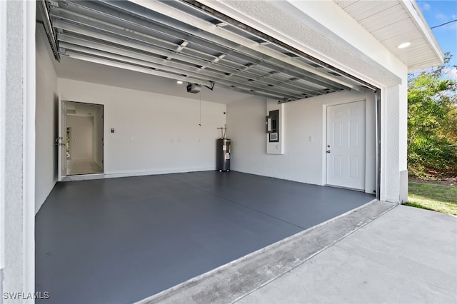 garage featuring a garage door opener, electric panel, and electric water heater