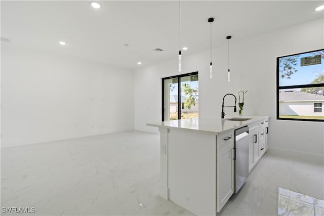 kitchen with pendant lighting, sink, dishwasher, white cabinets, and a center island with sink