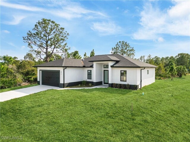 view of front of property with a garage and a front lawn