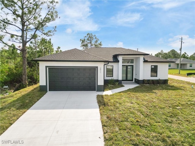 view of front of home featuring a garage and a front lawn