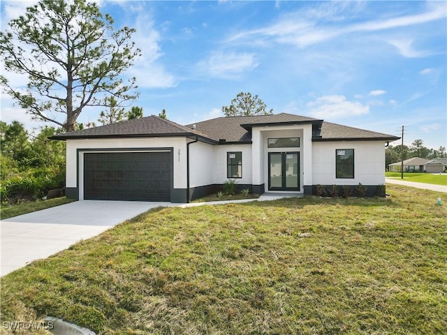 view of front of home with french doors, a garage, and a front yard