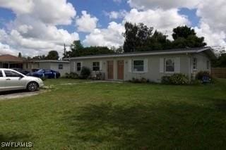 ranch-style home featuring a front lawn