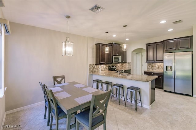 dining room with sink and light tile patterned floors