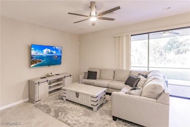 living room with ceiling fan and light tile patterned floors