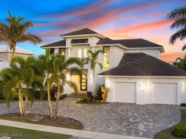 mediterranean / spanish-style house with a garage