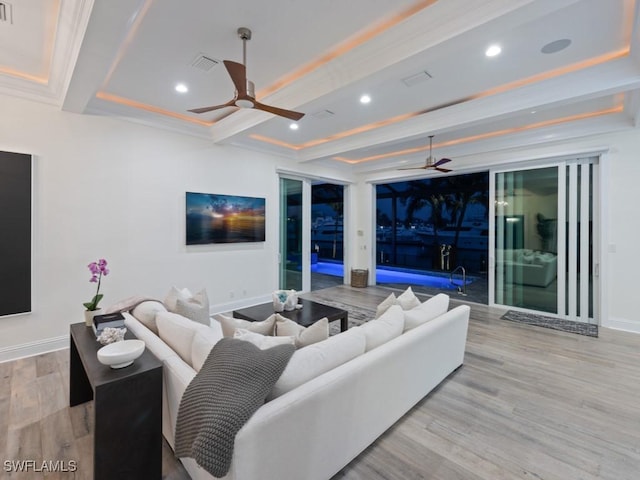 living room with crown molding, light hardwood / wood-style flooring, beam ceiling, and ceiling fan