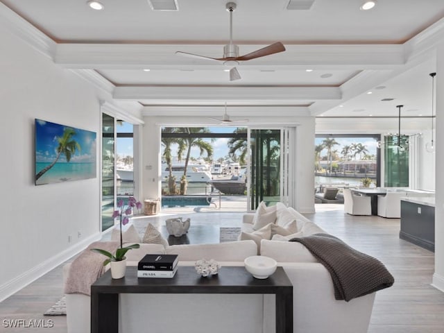 living room with light wood-type flooring, a water view, beamed ceiling, and ceiling fan