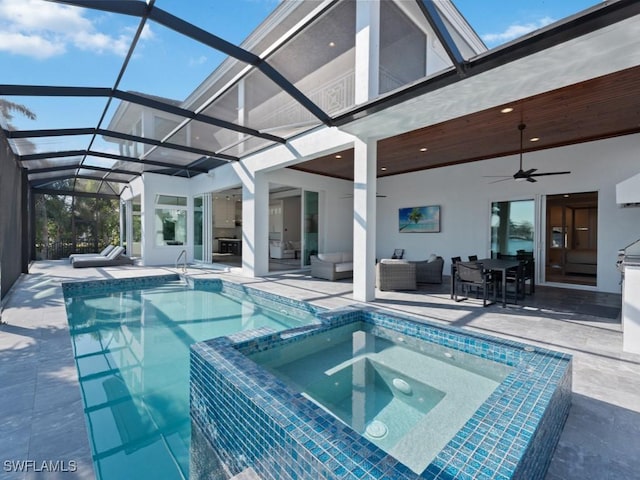 view of pool with glass enclosure, ceiling fan, an in ground hot tub, a patio, and an outdoor hangout area