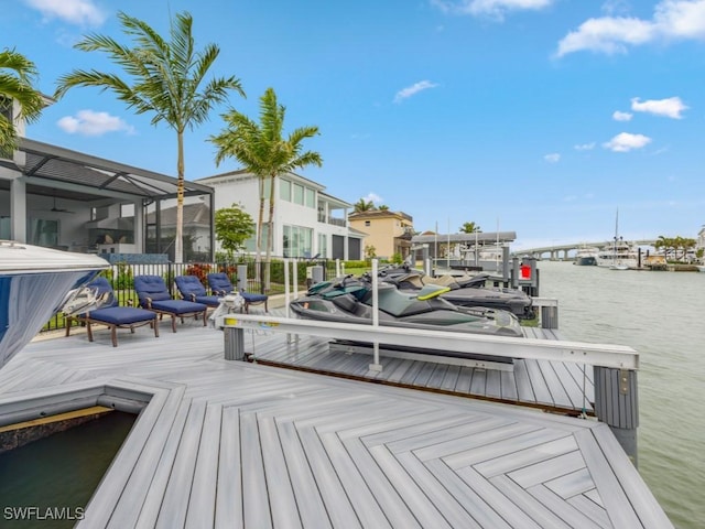 dock area featuring glass enclosure and a water view