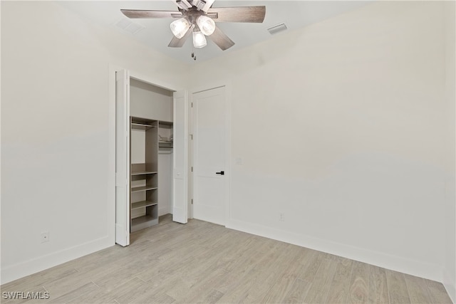 unfurnished bedroom with light hardwood / wood-style floors, a closet, and ceiling fan