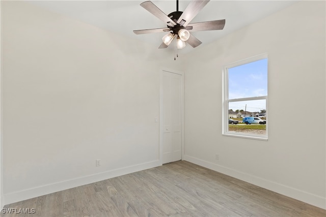 spare room with light wood-type flooring and ceiling fan