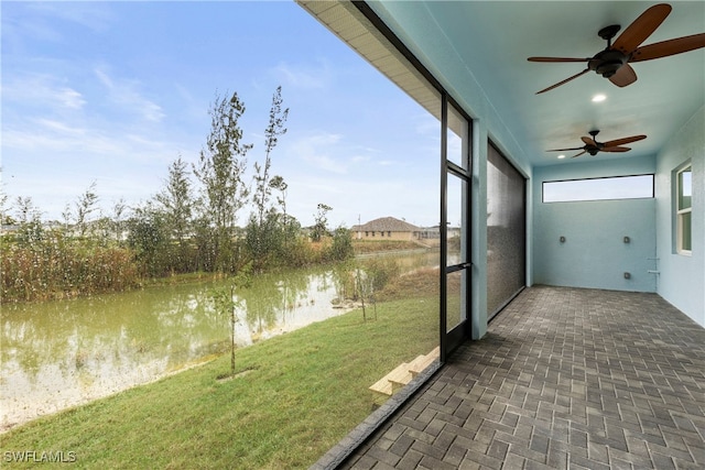 unfurnished sunroom featuring a water view