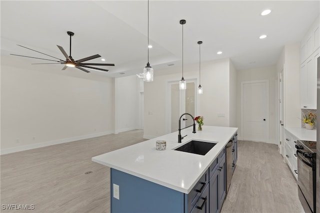 kitchen featuring sink, white cabinetry, hanging light fixtures, and black range oven