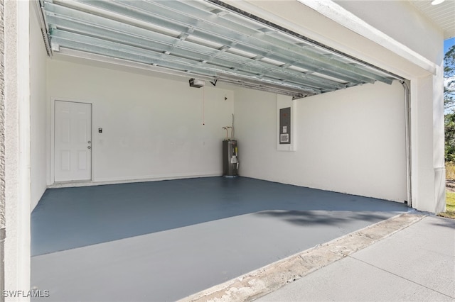 garage featuring a garage door opener, electric panel, and electric water heater