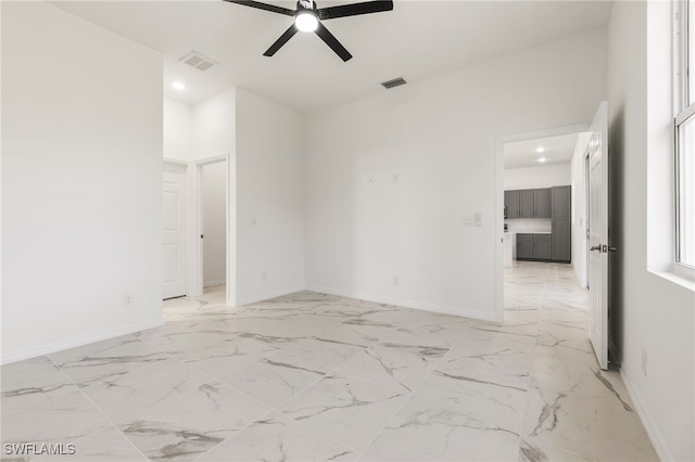 empty room featuring baseboards and visible vents