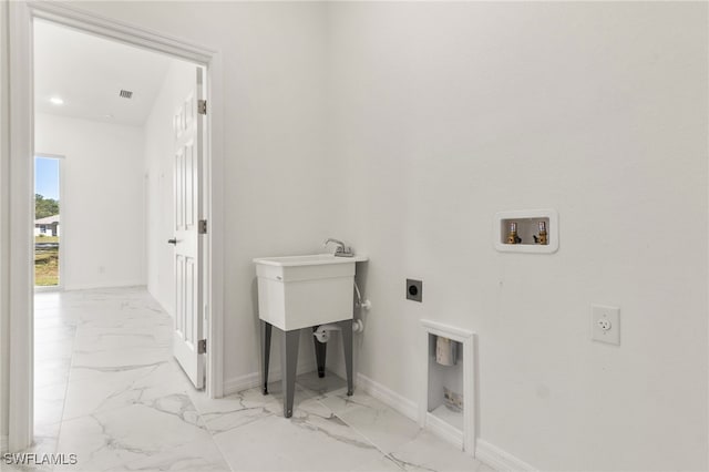 clothes washing area featuring marble finish floor, hookup for a washing machine, electric dryer hookup, laundry area, and baseboards