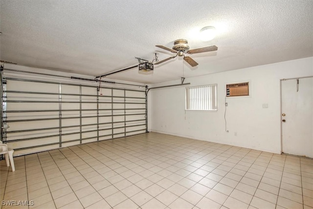 garage with a garage door opener, an AC wall unit, and ceiling fan