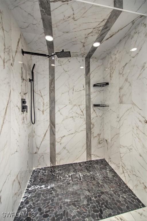 bathroom with tiled shower