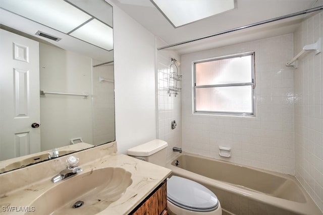 full bathroom with toilet, tiled shower / bath, and vanity