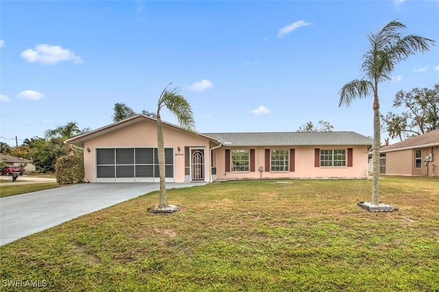 ranch-style house featuring a garage and a front lawn