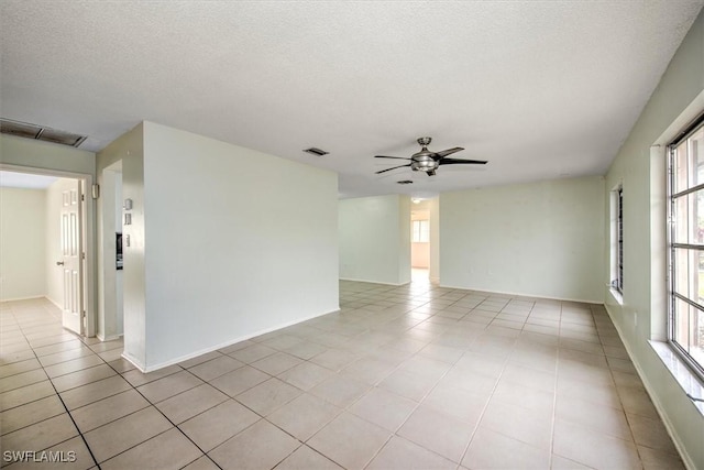 tiled spare room featuring ceiling fan and a textured ceiling