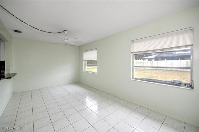 tiled empty room with ceiling fan