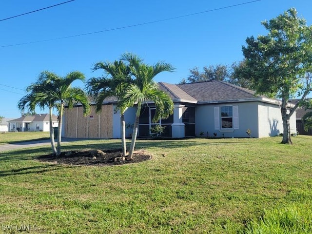 ranch-style home featuring a front lawn