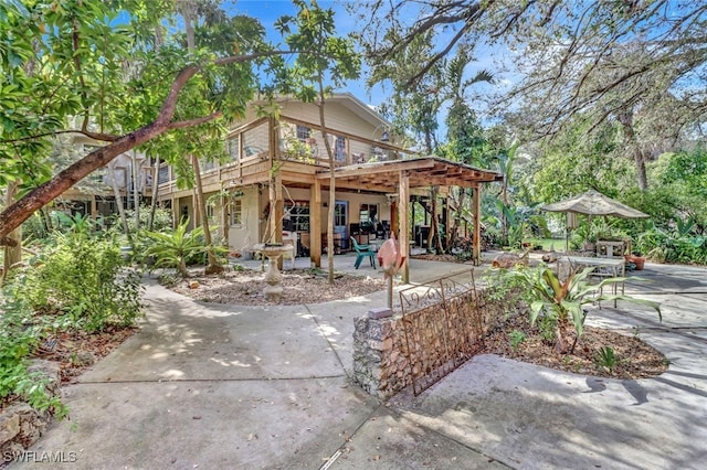 rear view of property featuring a patio