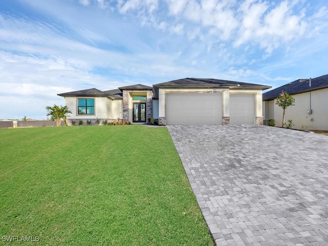 prairie-style home with a garage and a front yard