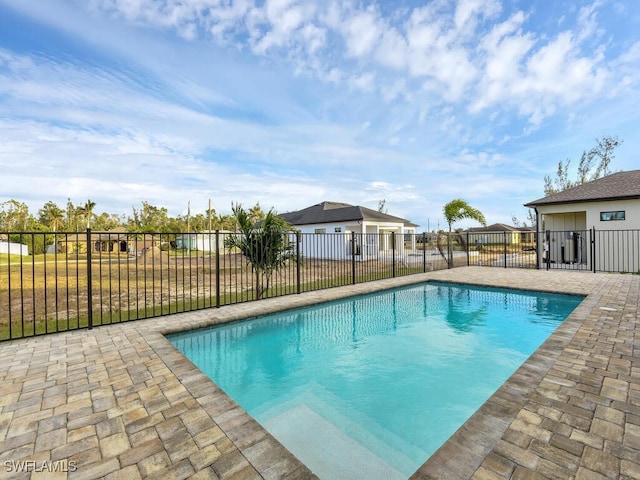 view of pool featuring fence, a fenced in pool, and a patio