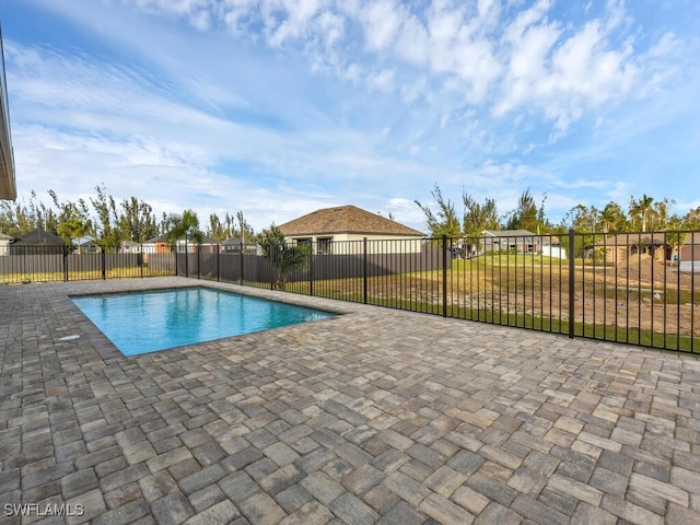 view of pool with a patio, a yard, a fenced backyard, and a fenced in pool