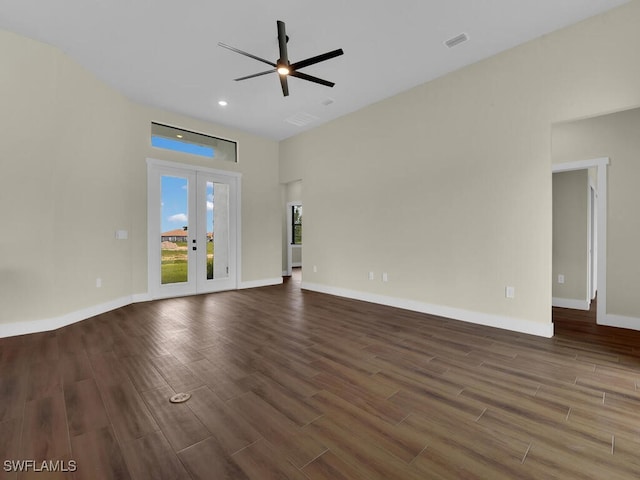 unfurnished living room with baseboards, visible vents, dark wood-style flooring, and french doors