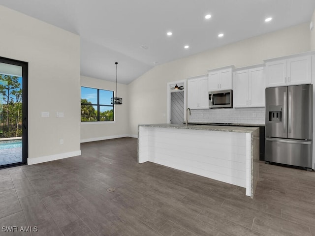 4116 NE 21st Pl, Cape Coral, FL 33909 - kitchen featuring a center island with sink, backsplash, white cabinets, and stainless steel appliances