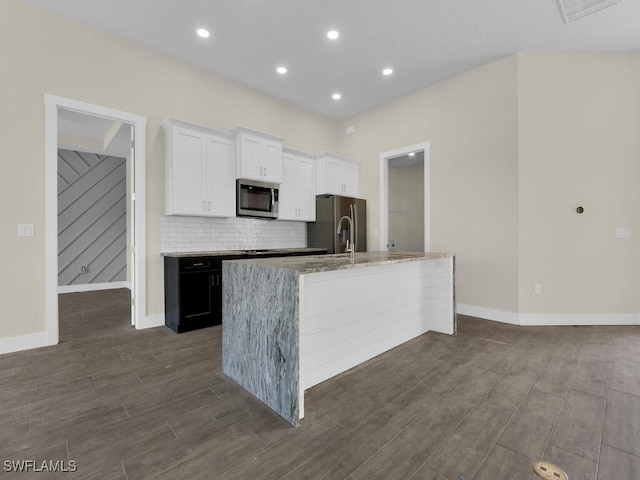 4116 NE 21st Pl, Cape Coral, FL 33909 - kitchen featuring light stone countertops, white cabinets, dark wood finished floors, backsplash, and stainless steel appliances