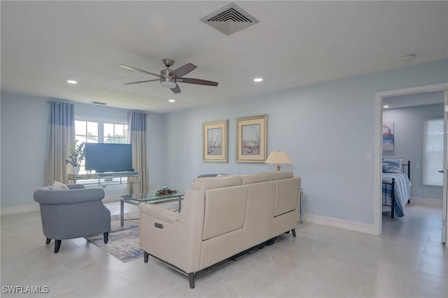 tiled living room featuring ceiling fan