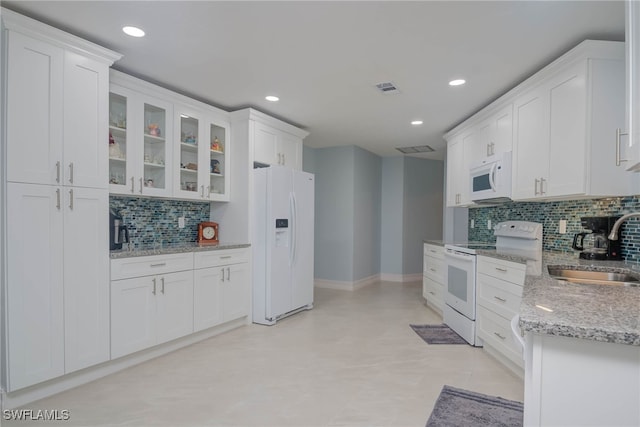 kitchen featuring sink, white appliances, and white cabinets