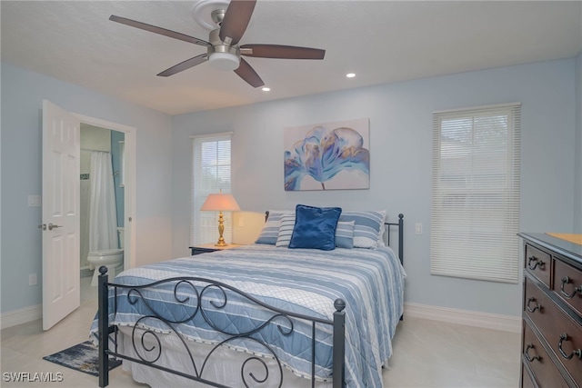 bedroom featuring ensuite bath and ceiling fan