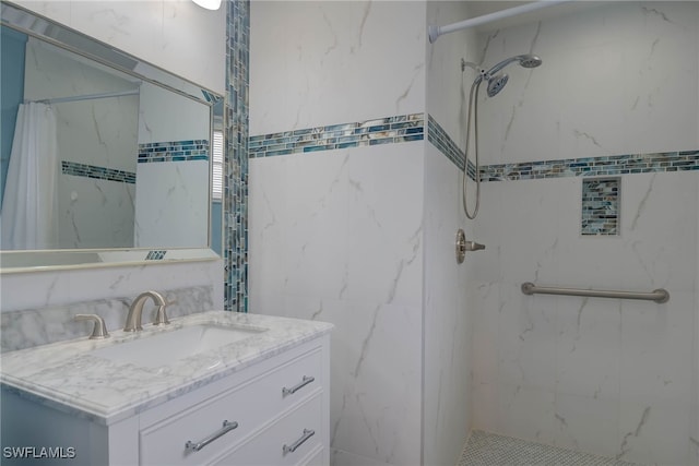 bathroom with vanity, tile walls, and walk in shower