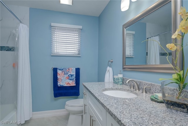 full bathroom with vanity, shower / tub combo, and toilet