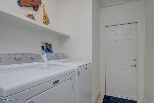 clothes washing area featuring washer and clothes dryer