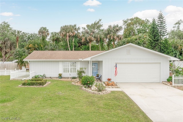 14943 Randolph Dr, Fort Myers, FL 33905 - single story home featuring a front yard, driveway, a garage, and fence