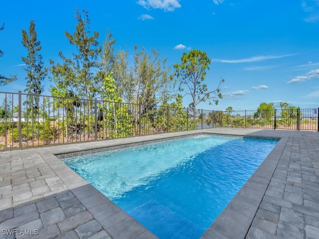 view of swimming pool featuring fence, a fenced in pool, and a patio