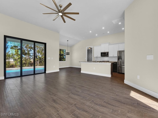 unfurnished living room with recessed lighting, baseboards, a ceiling fan, and dark wood-style floors
