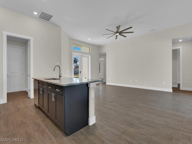 kitchen with a sink, visible vents, and open floor plan