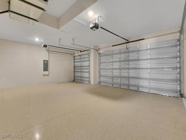 garage with a garage door opener and electric panel