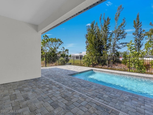view of pool with a patio, a fenced in pool, and fence