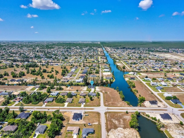 birds eye view of property featuring a residential view and a water view