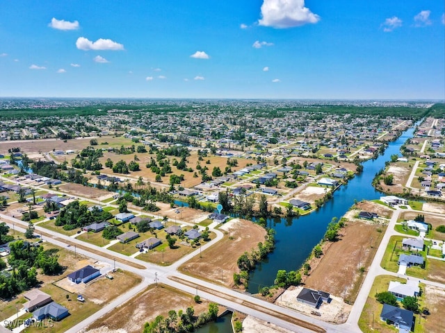 drone / aerial view featuring a water view and a residential view