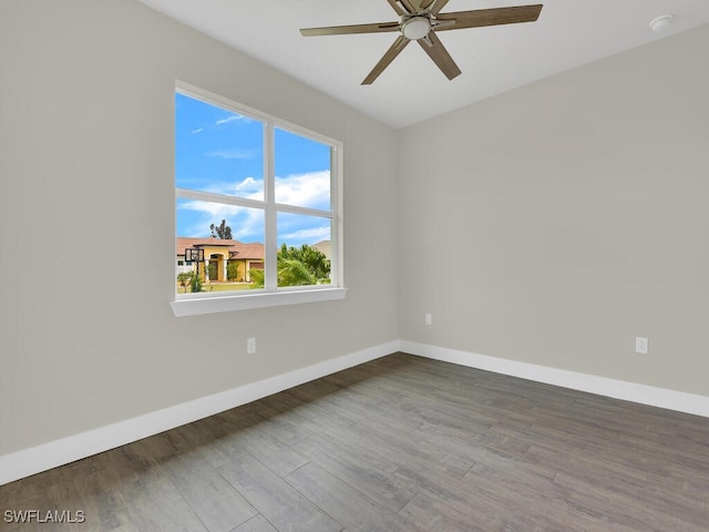 unfurnished room featuring a ceiling fan, baseboards, and wood finished floors