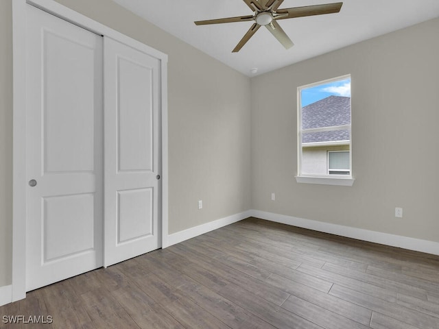 unfurnished bedroom featuring baseboards, ceiling fan, and wood finished floors